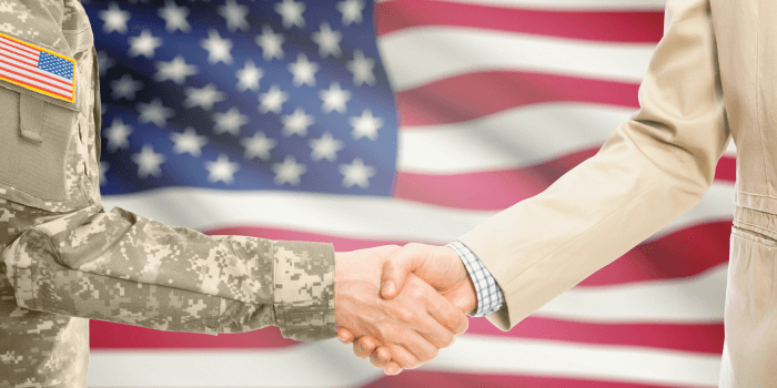 veteran shaking hands with business person